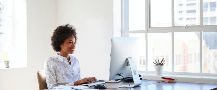 young-black-woman-working-at-computer-in-an-office